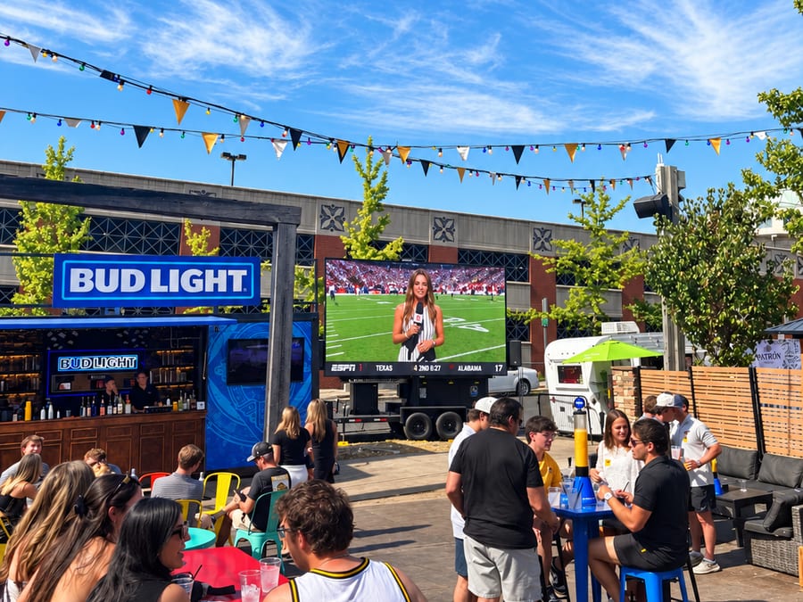 Showtime 16′ × 9′ LED trailer showing a college football broadcast at an outdoor patio watch party